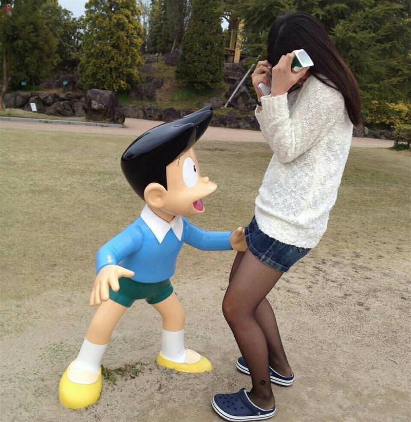 Girls posing with their favorite statues