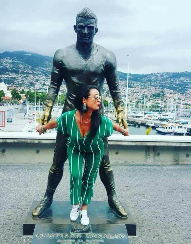 Girls posing with their favorite statues