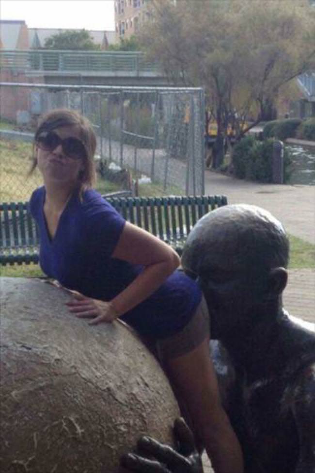 Girls posing with their favorite statues