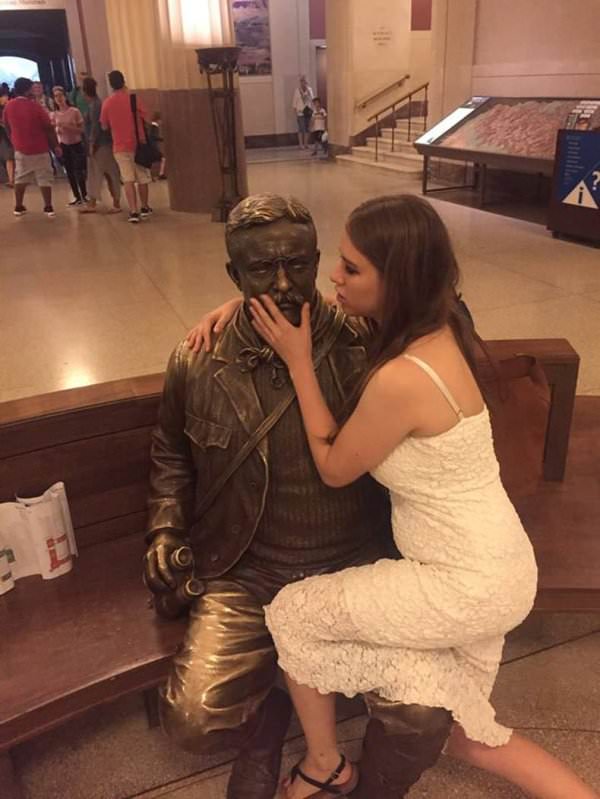 Girls posing with their favorite statues