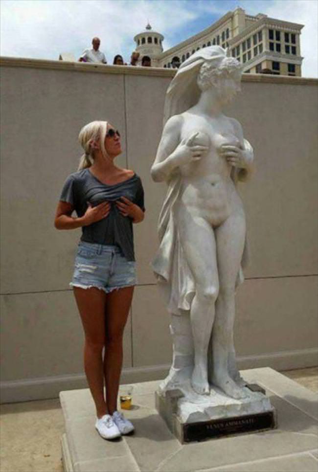 Girls posing with their favorite statues