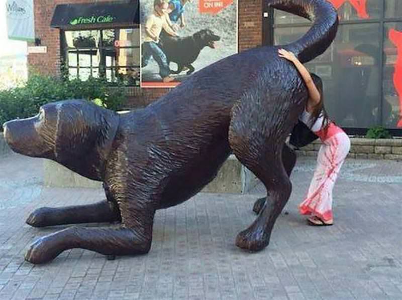 Girls posing with their favorite statues