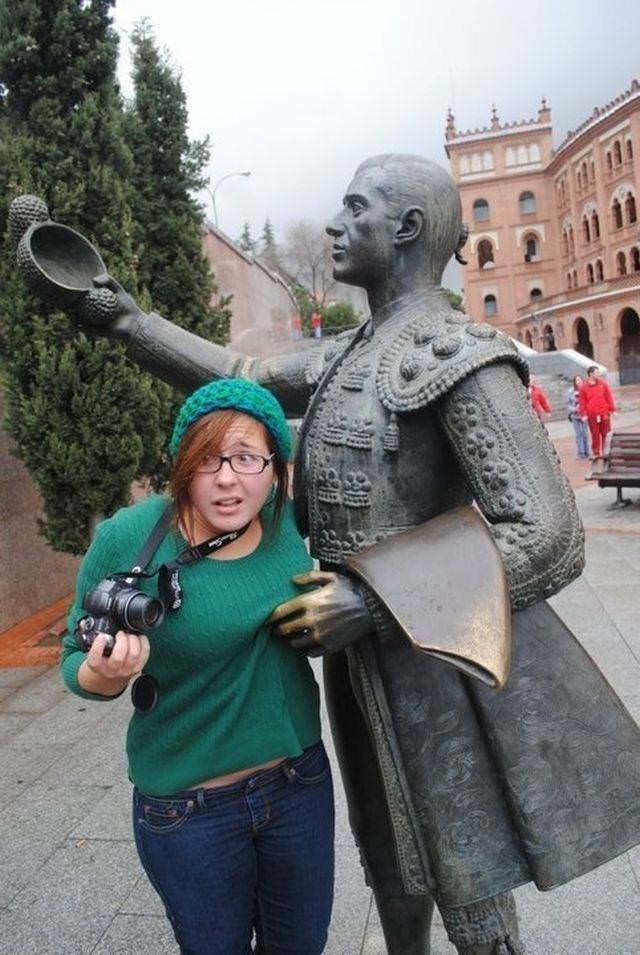 Girls posing with their favorite statues