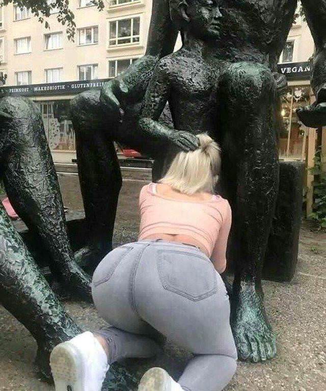 Girls posing with their favorite statues