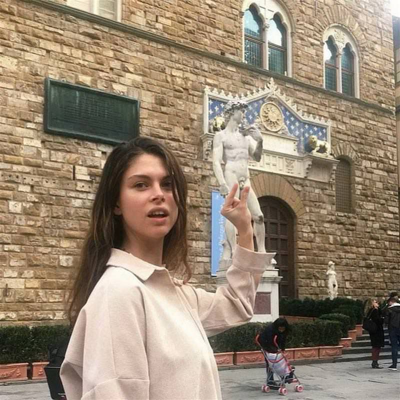 Girls posing with their favorite statues